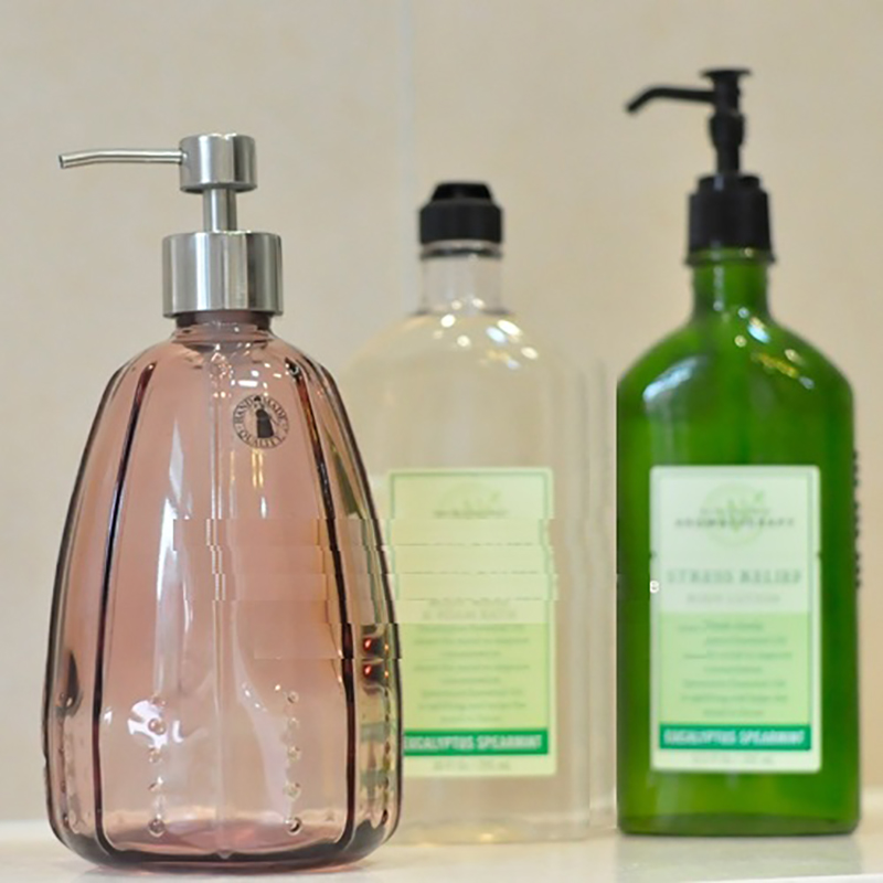 Leather covered hand sanitizer, shower gel, glass bottle